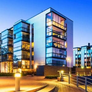 Modern illuminated apartment building at dusk